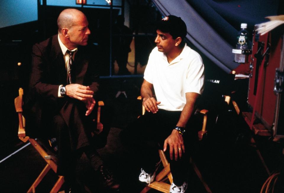 Bruce Willis and M. Night Shyamalan on the set of 2000’s “Unbreakable.” Touchstone/Kobal/Shutterstock