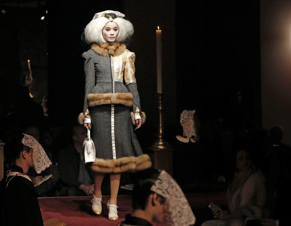 A model walks the runway during the presentation of the Thom Browne Fall 2014 collection in New York, Monday, Feb. 10, 2014. (AP Photo/Kathy Willens)