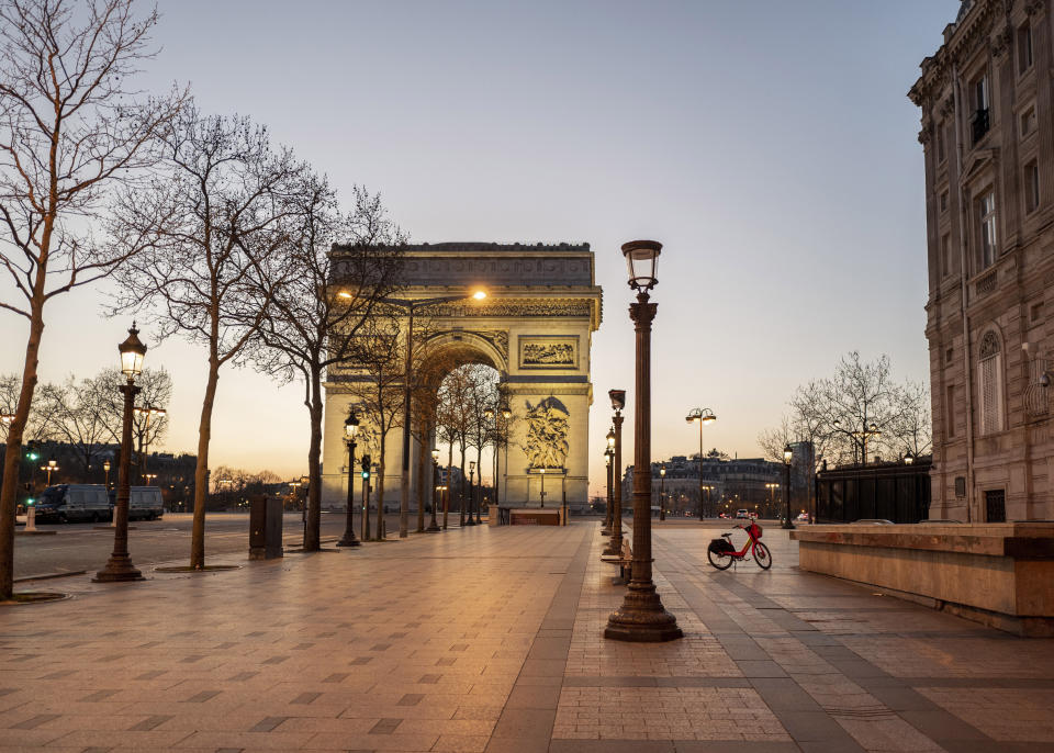 FILE- Empty Champs Elysees avenue as the 7 p.m curfew starts in Paris, France, on Saturday, March 20, 2021. Some 4,400 of the world's best athletes, parading down France's most famous boulevard with their prosthetic limbs, mobility chairs and stories of adversities overcome, to a grand celebration of their prowess and sports on the Paris square where the French revolutionaries of 1789 chopped off heads. (AP Photo/Rafael Yaghobzadeh, File)