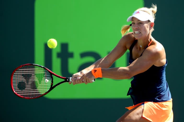 Angelique Kerber of Germany returns a shot to Risa Ozaki of Japan during their Miami Open 4th round match, at the Crandon Park Tennis Center in Key Biscayne, Florida, on March 27, 2017