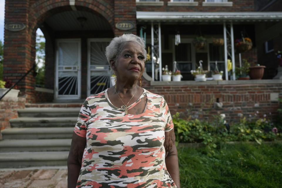 Pamela Jackson-Walters stands outside her home in Detroit, Wednesday, Sept. 21, 2022. Jackson-Walters uses her home internet connection to attend church services virtually and to pursue a graduate degree, but the service AT&T offers in her mostly Black neighborhood is much slower than in other parts of the city. She said she also experienced an internet outage for four weeks during the summer.(AP Photo/Paul Sancya)