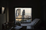 FILE - In this August 13, 2020 file photo, damaged buildings can be seen from a broken window in the Saint George Hospital, that was heavily damaged in the Aug. 4 massive explosion in Beirut, Lebanon. The health services and facilities in Lebanon were once considered among the region’s best. But in a short time, they have been brought to near collapse, battered by Lebanon’s financial meltdown and a surge in coronavirus cases, then smashed by the Beirut explosion. (AP Photo/Felipe Dana, File)