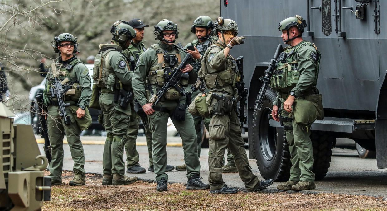 DeKalb, Ga., and Atlanta SWAT members are pictured leaving the Gresham Park command post in Atlanta on Wednesday, Jan. 18, 2023.