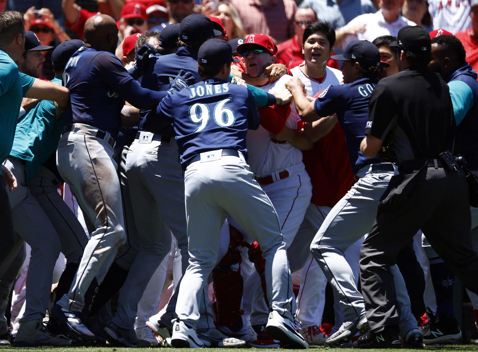 ANAHEIM, CALIFORNIA - JUNE 26:   The Seattle Mariners and the Los Angeles Angels clear the benches after Jesse Winker #27 of the Seattle Mariners charged the Angels dugout after being hit by a pitch in the second inning at Angel Stadium of Anaheim on June 26, 2022 in Anaheim, California. (Photo by Ronald Martinez/Getty Images)