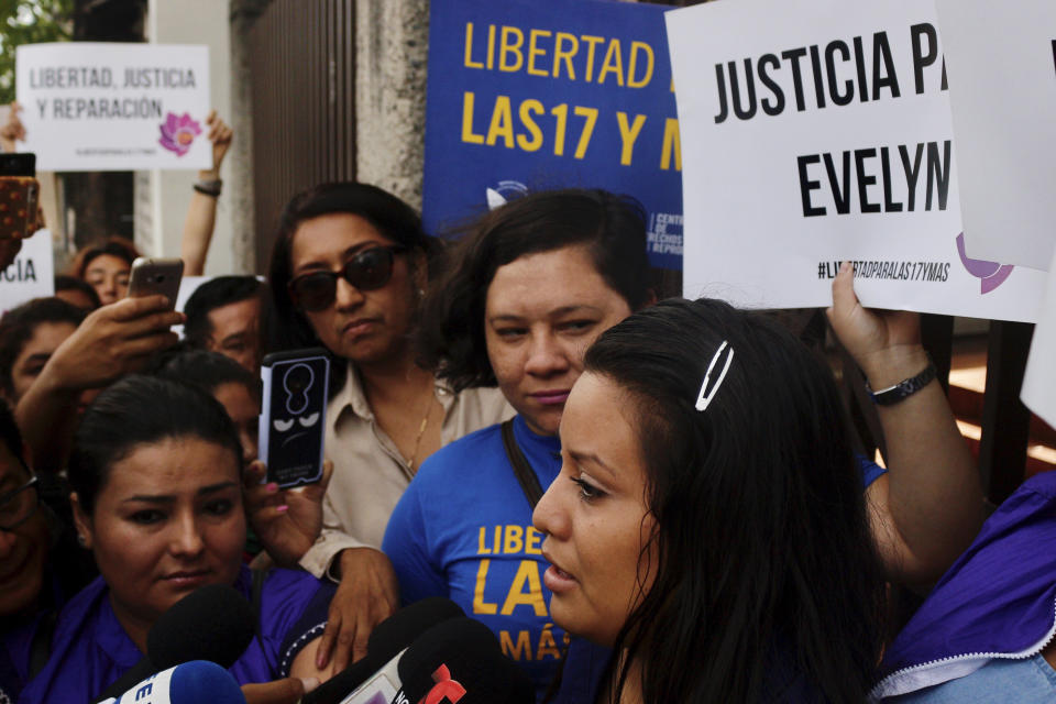 Evelyn Beatriz Hernandez, front, walks past protestors supporting her as she arrives at court for a new trial with a new judge after her 30-year sentence for abortion was overturned in February, in Ciudad Delgado, on the outskirts of San Salvador, El Salvador, Monday, July 15, 2019. The young woman who birthed a baby into a toilet in El Salvador faces a second trial for murder Monday, after having already served 33 months, in a case that has drawn international attention because of the country's highly restrictive abortion laws. (AP Photo/Salvador Melendez)