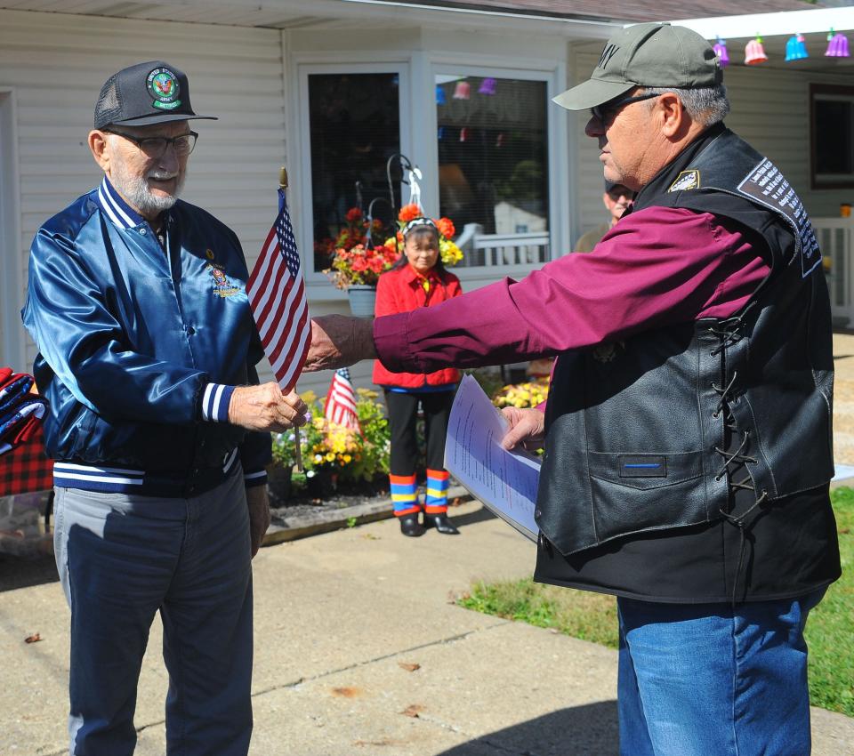 Jim Myers, right, presents an American flag to veteran Kenneth Harper on Saturday, Oct. 8, 2022, at the Honoring Our True Heroes mission event.
