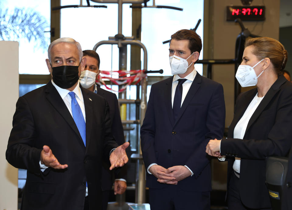 Israeli Prime Minister Benjamin Netanyahu, left, visits a fitness gym with Austrian Chancellor Sebastian Kurz, center, and Danish Prime Minister Mette Frederiksen, to observe how the "Green Pass," for citizens vaccinated against COVID-19, is used, in Modi'in, Israel, Thursday, March 4, 2021. Frederiksen and Kurz are on a short visit to Israel for to pursue the possibilities for closer cooperation on COVID-19 and vaccines. (Avigail Uzi/Pool via AP)