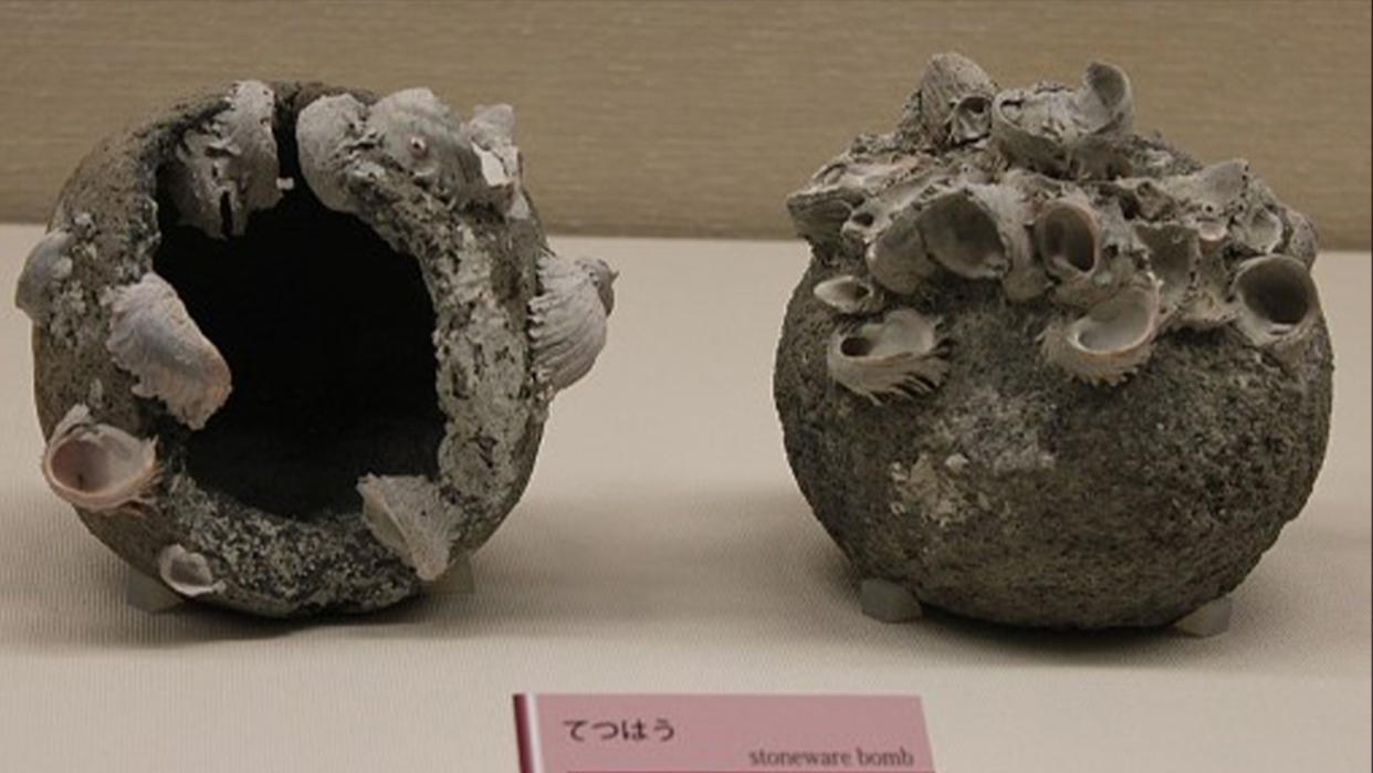  400-year-old stone-shelled grenades unearthed near the Badaling Great Wall. Large, heavy dark gray spheres with included materials and seashells. 