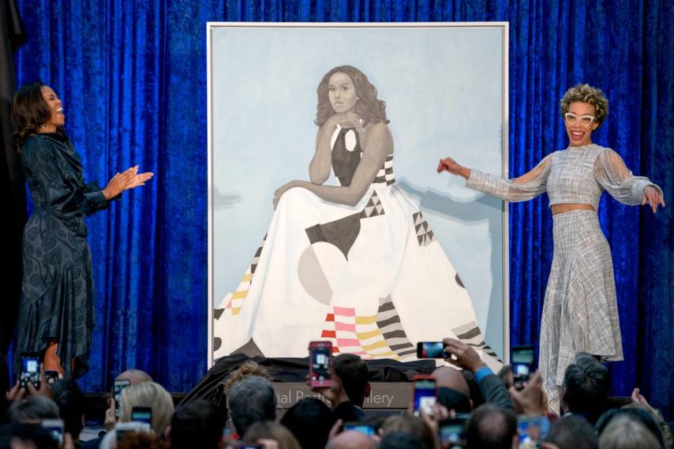Former first lady Michelle Obama and artist Amy Sherald, right, unveil Michelle Obama’s official portrait at the Smithsonian’s National Portrait Gallery, Feb. 12, 2018, in Washington.