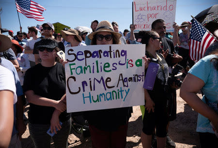 People participate in a protest against a recent U.S. immigration policy of separating children from their families when they enter the United States as undocumented immigrants, outside the Tornillo Tranit Centre, in Tornillo, Texas, U.S. June 17, 2018. REUTERS/Monica Lozano