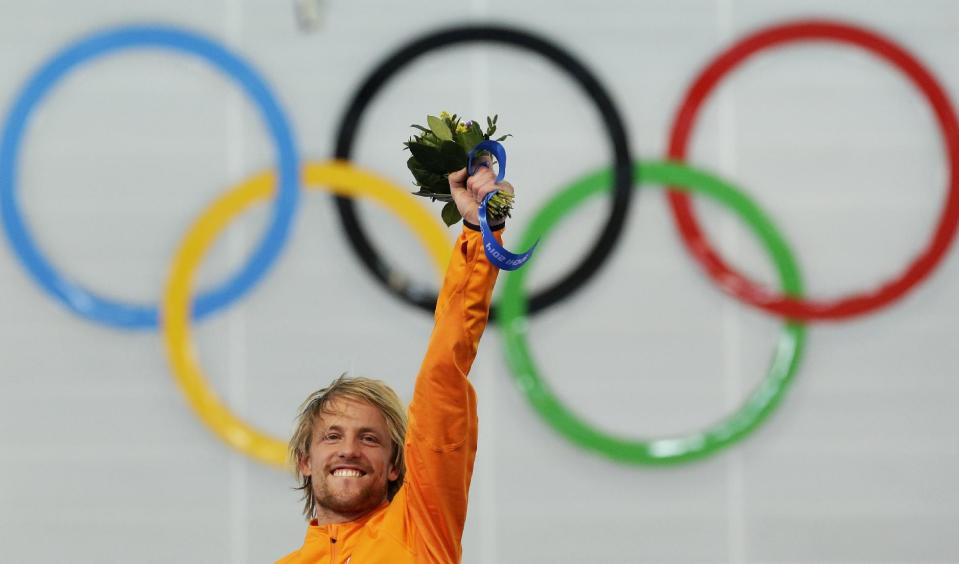 Gold medallist Michel Mulder of the Netherlands celebrates during the flower ceremony for the men's 500-meter speedskating race at the Adler Arena Skating Center at the 2014 Winter Olympics, Monday, Feb. 10, 2014, in Sochi, Russia. (AP Photo/Patrick Semansky)