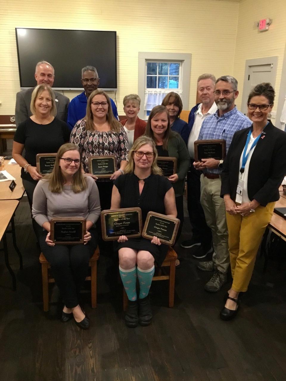 Members of the Madison County Board of Education and school administration pose with the Madison County Schools' six teachers of the year, as well as the principal of the year.