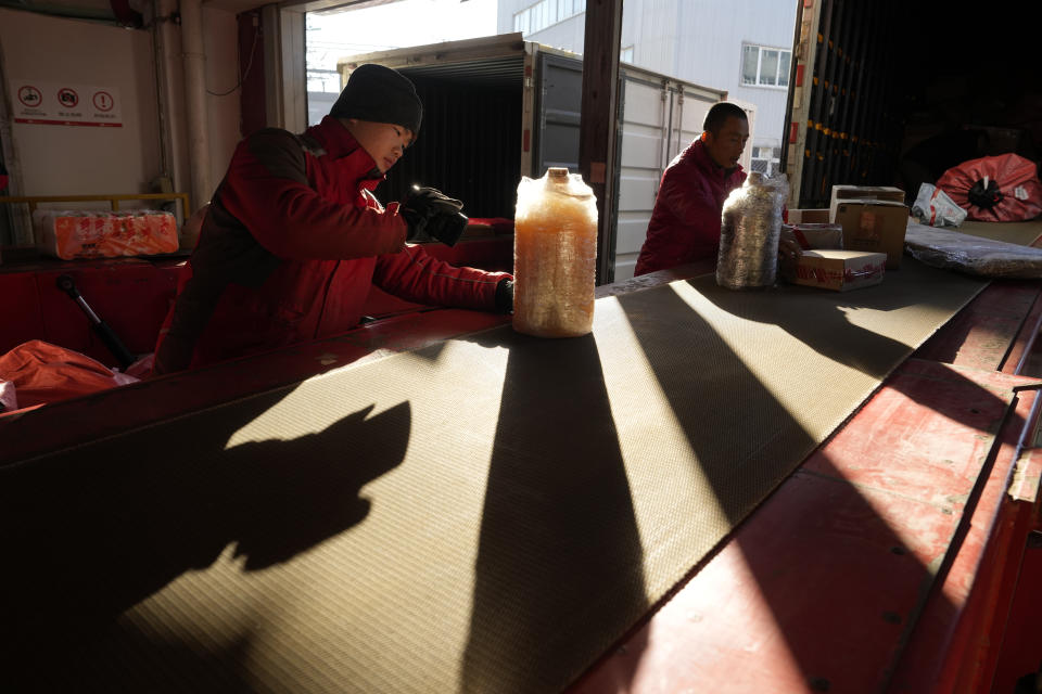 Workers sort out parcels at a distribution center for e-commerce platform JD.com in Beijing, Saturday, Nov. 11, 2023. Shoppers in China have been tightening their purse strings, raising questions over how faltering consumer confidence may affect the annual Singles' Day online retail extravaganza. (AP Photo/Ng Han Guan)