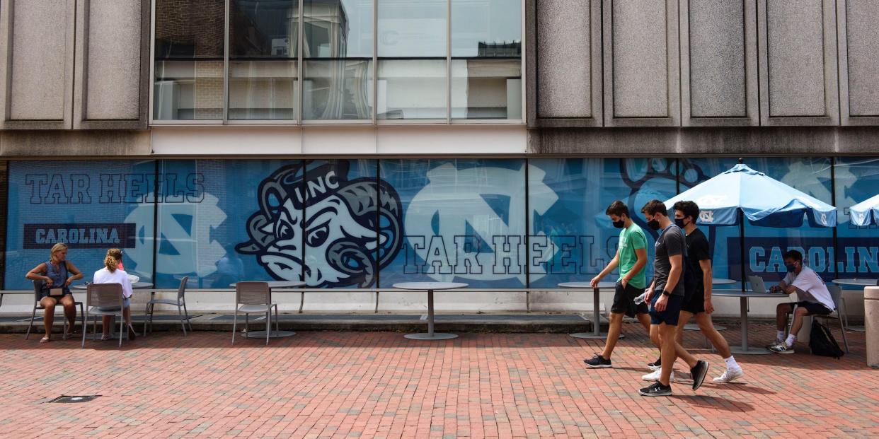 Students walk through the campus of the University of North Carolina at Chapel Hill on August 18, 2020 in Chapel Hill, North Carolina.