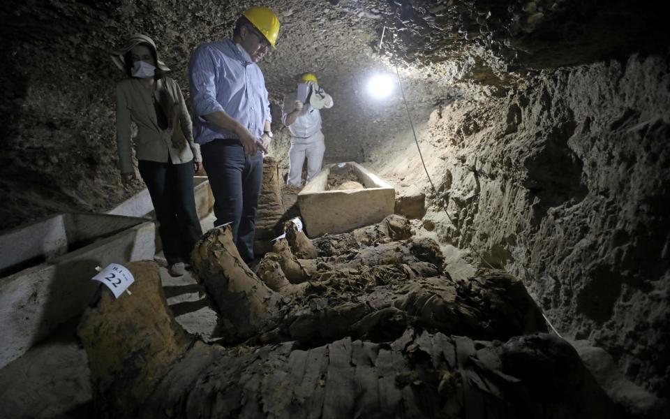 Egyptian Minister of Antiquities Khaled Al-Anani inside a newly discovered burial site in Minya, Egypt.  - Credit: AFP