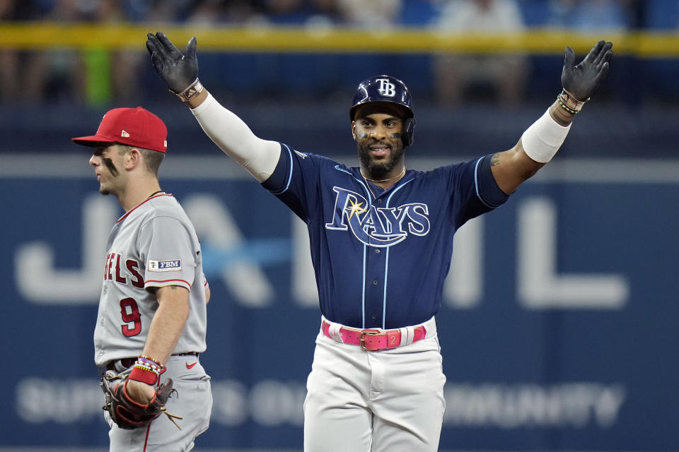 Tampa Bay Rays' Yandy Diaz reacts behind Los Angeles Angels shortstop Zach Neto (9) after his two-run double off relief pitcher Andrew Wantz during the sixth inning of a baseball game Wednesday, Sept. 20, 2023, in St. Petersburg, Fla. (AP Photo/Chris O'Meara)