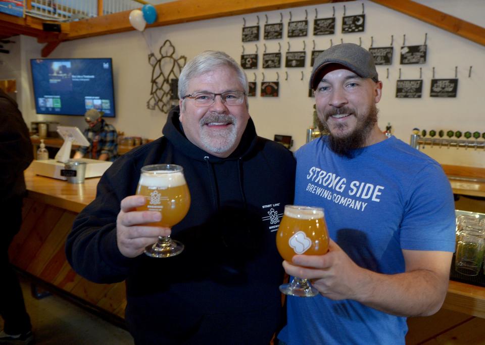 Start Line Brewing Co. founder Ted Twinney, left, and David Hughes, owner of Strong Side Brewing, a collaboration with Start Line Brewing, at the release party at Start Line Brewing Co. in Hopkinton, Jan. 27, 2022.