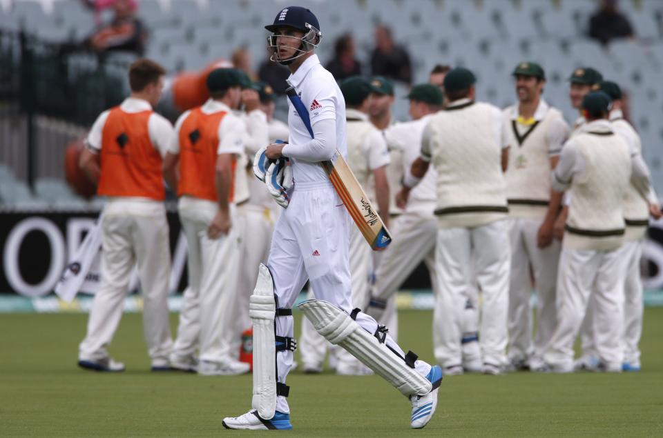 England's Stuart Broad walks off the field after his dismissal as Australia's team celebrate during the fifth day's play in the second Ashes cricket test at the Adelaide Oval December 9, 2013. REUTERS/David Gray (AUSTRALIA - Tags: SPORT CRICKET)