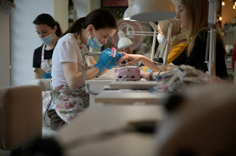Manicures at a nail bar (AFP/Natalia KOLESNIKOVA)