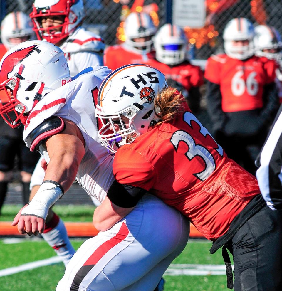 Taunton’s Tanner Brannon tackles Milford’s Romeo Holland during Thursday’s Thanksgiving Day game.