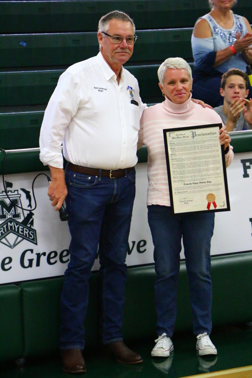 Kim Freis, the daughter of the late Coach Gary Freis, accepts the Proclamation on behalf of her father at the Gary Freis Duals held Saturday, Dec. 4 at Fort Myers High School.