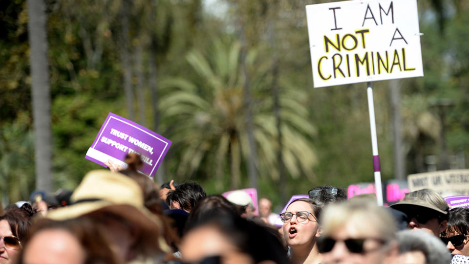 A photo of pro-life protestors with a sign, saying: "I am not a criminal." The abortion bill was debated for nearly 40 hours.