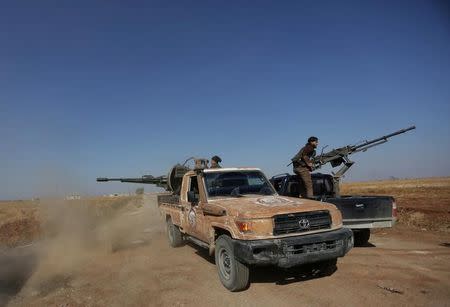Rebel fighters in Marea city shoot a weapon towards Syria Democratic Forces (SDF) controlled Tell Rifaat town, northern Aleppo province, Syria October 21, 2016. REUTERS/Khalil Ashawi