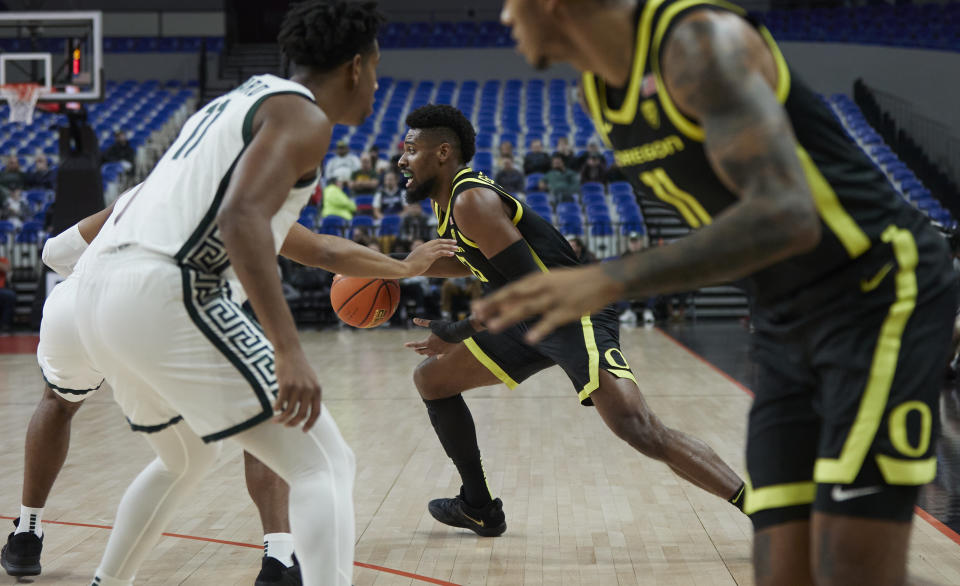 Oregon forward Quincy Guerrier dribbles during the first half of the team's NCAA college basketball game against Michigan State in the Phil Knight Invitational tournament in Portland, Ore., Friday, Nov. 25, 2022. (AP Photo/Craig Mitchelldyer)