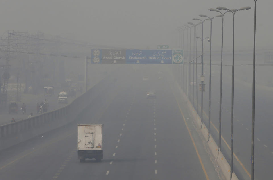 Vehicles drive on a highway as smog envelops the area of Lahore, Pakistan, Wednesday, Nov. 11, 2020. People in Pakistan’s cultural capital of Lahore were at risk of respiratory diseases and eye-related problems Wednesday after the air quality deteriorated to hazardous levels due to a quilt of smog over the city, prompting doctors to urge people to stay at home. (AP Photo/K.M. Chaudary)