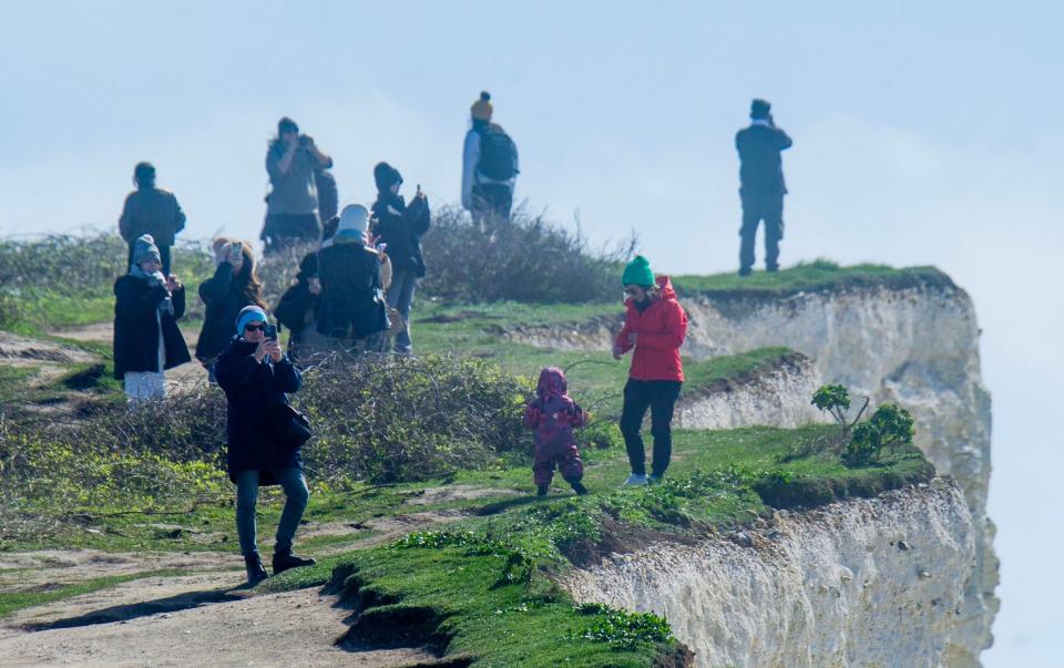 Crowds of people are still risking their lives for a picture and a view of the beach at Birling Gap in Sussex