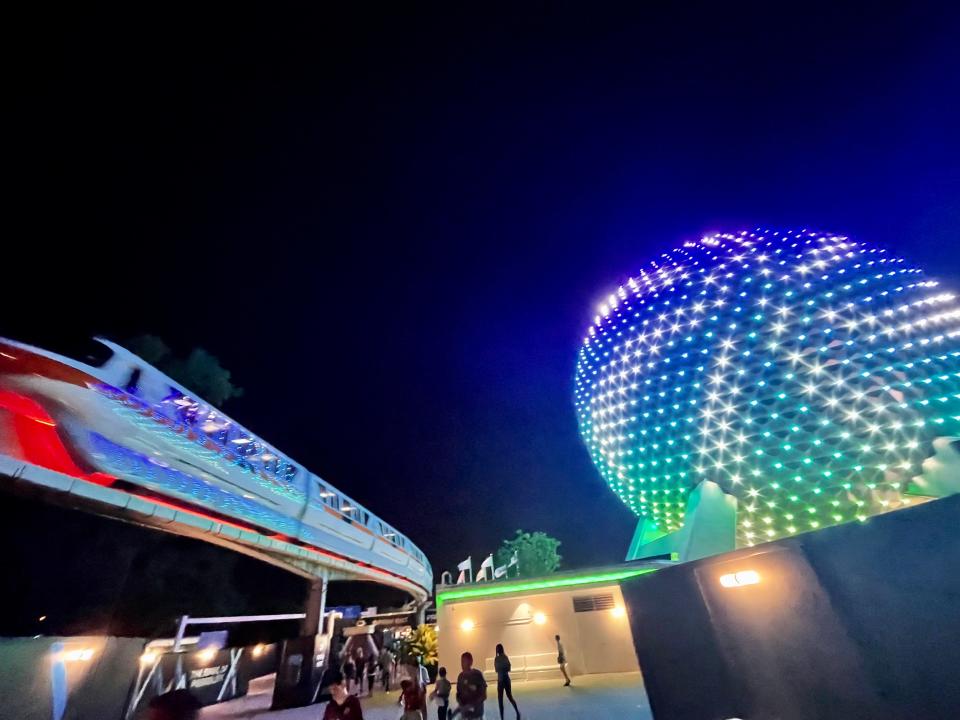monorail lit up at night for disney world 50th anniversary