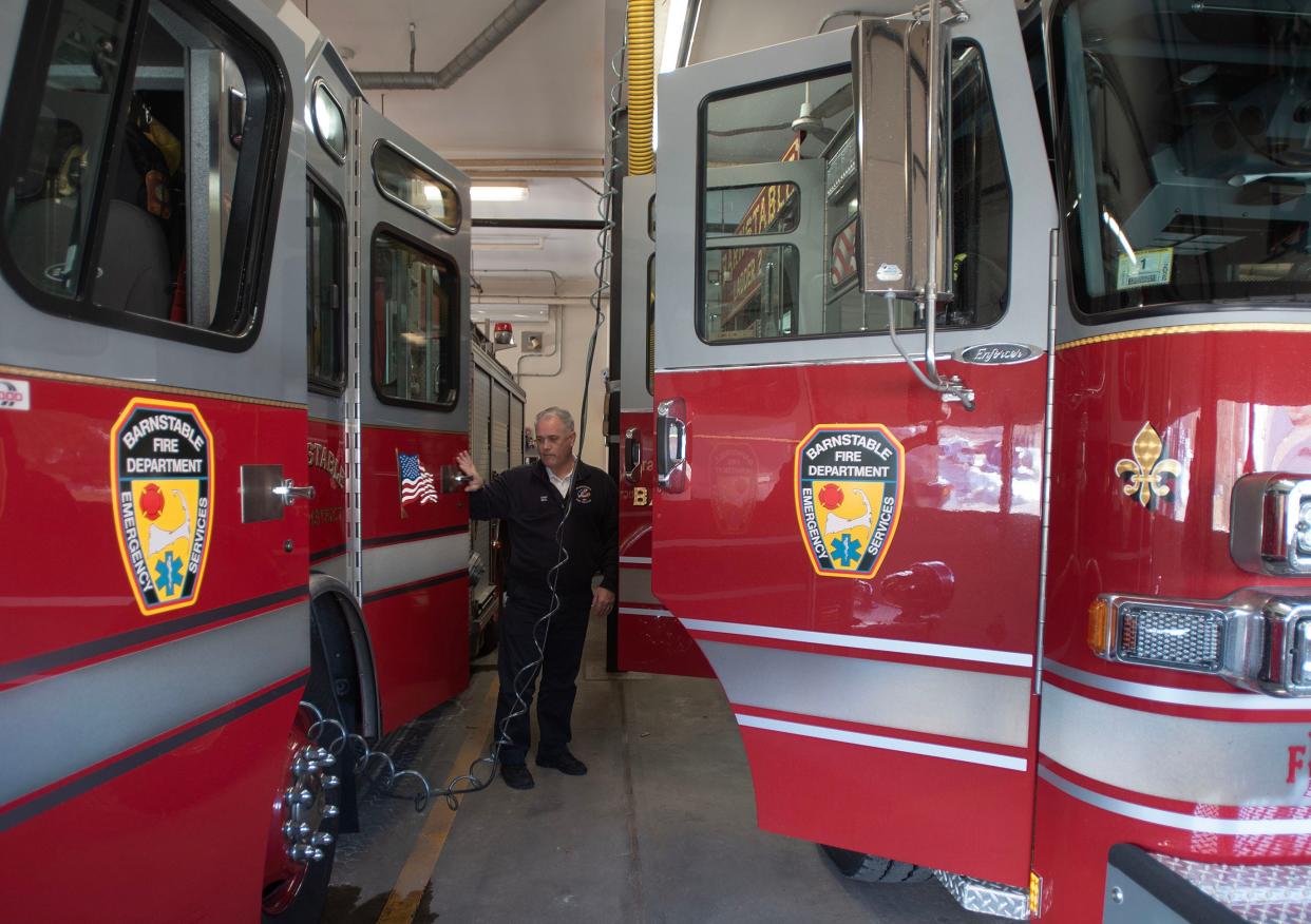 Barnstable Fire Chief Chris Beal shows on Wednesday how little space there is between vehicles in the crowded bays at the fire station at 3249 Main St. Plans for a new station on Phinney's Lane are underway.