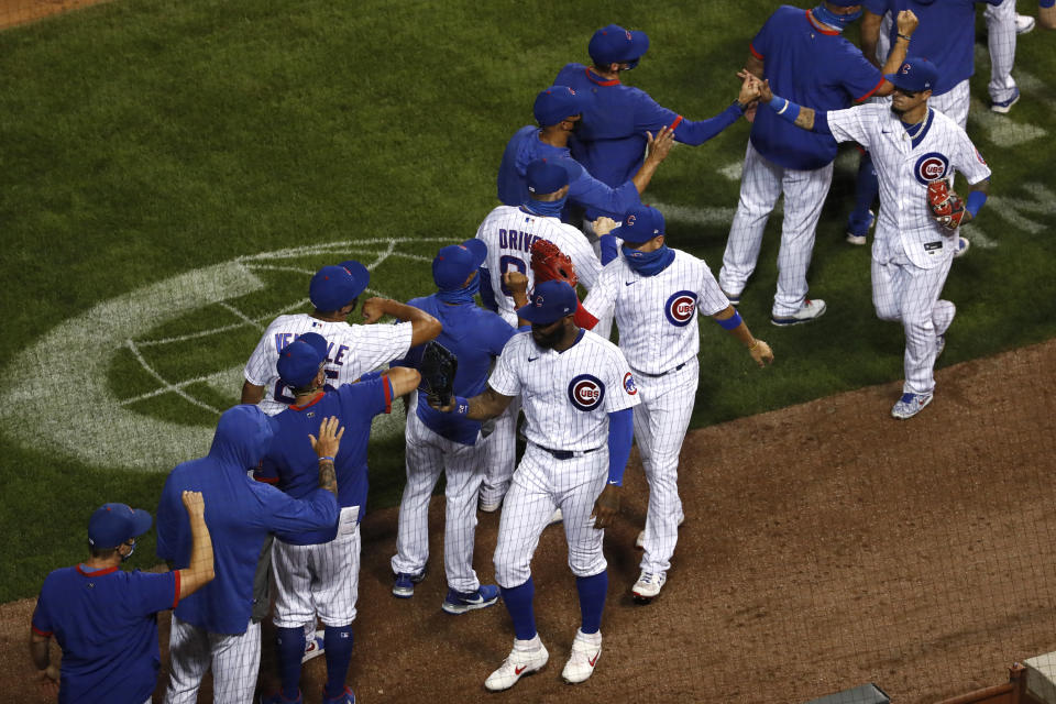 The Chicago Cubs celebrate after beating the Milwaukee Brewers during a baseball game in Chicago, on Thursday, Aug. 13, 2020. The Cubs won the game 4-2. (AP Photo/Jeff Haynes)