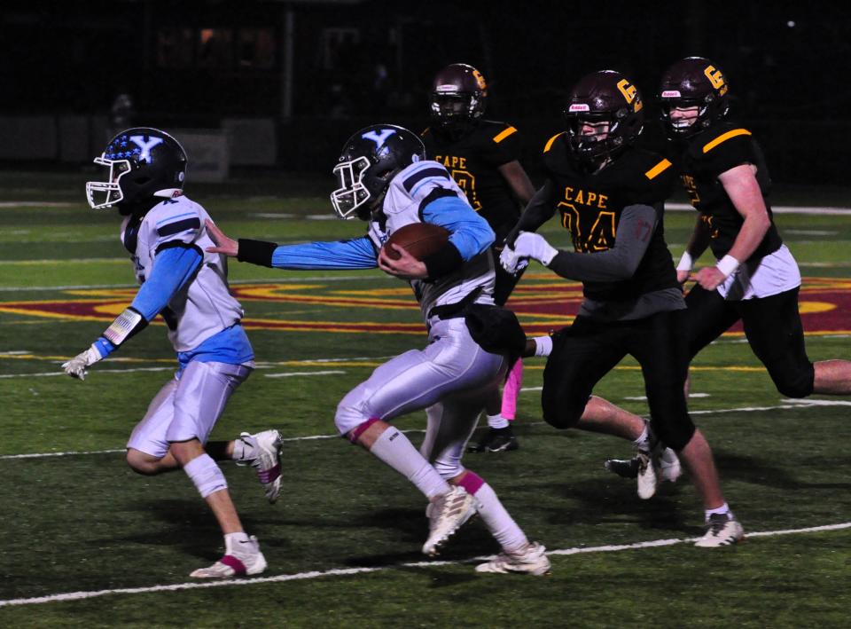 York’s Gavin Davis, right, follows the block of SamHarper Rios-Martine during Monday night’s Class B South playoff game in Cape Elizabeth, Maine.