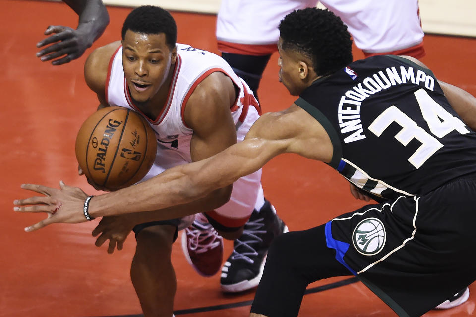 Toronto Raptors guard Kyle Lowry (7) protects the ball from Milwaukee Bucks forward Giannis Antetokounmpo (34) during second-half NBA playoff basketball game action in Toronto, Saturday, April 15, 2017. (Nathan Denette/The Canadian Press via AP)