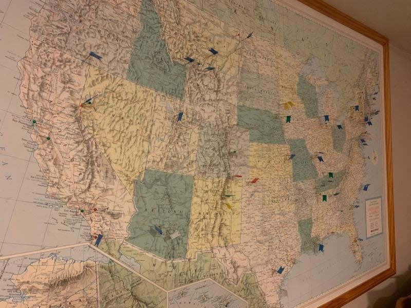 Dana Almeida has a map of the United States hanging in his basement to track where he has played golf.