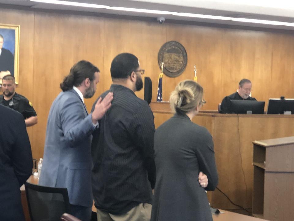 Defense attorney Peter Conley placed his hand on the back of his client, murder defendant Yanez Sanford, during Thursday's reading of a jury's verdict finding Sanford not guilty on all counts of charges he faced linked to a 2016 Topeka triple homicide.