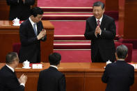 Chinese President Xi Jinping, top right, applauds as he leaves after the closing session of the National People's Congress held at the Great Hall of the People in Beijing, Monday, March 11, 2024. (AP Photo/Ng Han Guan)