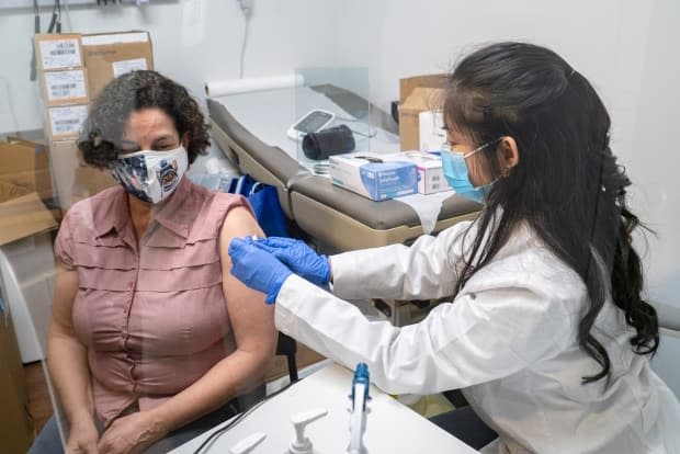 A woman gets a dose of the AstraZeneca COVID-19 vaccine in Toronto last month. Seven new cases were reported in N.S. on Sunday. There is also confirmation of a case of the variant first detected in Brazil. (Sam Nar/CBC - image credit)