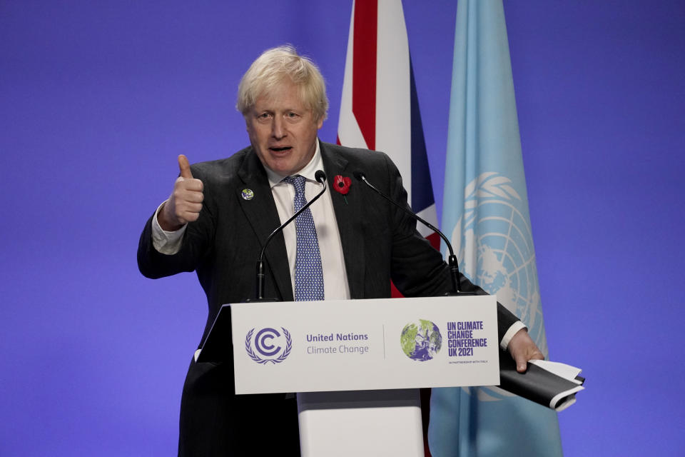 British Prime Minister Boris Johnson gives a thumbs-up as he finishes his press conference at the COP26 U.N. Climate Summit, in Glasgow, Scotland, Wednesday, Nov. 10, 2021. The U.N. climate summit in Glasgow has entered its second week as leaders from around the world, are gathering in Scotland's biggest city, to lay out their vision for addressing the common challenge of global warming. (AP Photo/Alberto Pezzali)