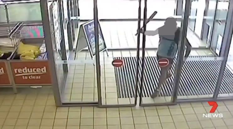 The man can be seen entering a store wielding an aluminium bat. Source: 7 News