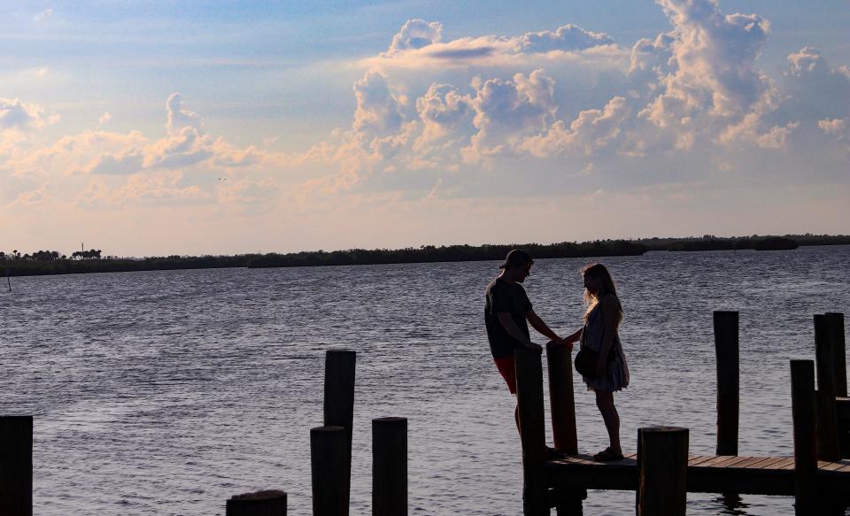 A couple enjoys the sunset as they wait to be seated at JB’s Fish Camp located along the Indian River Lagoon, where dolphins and manatees are often spotted.