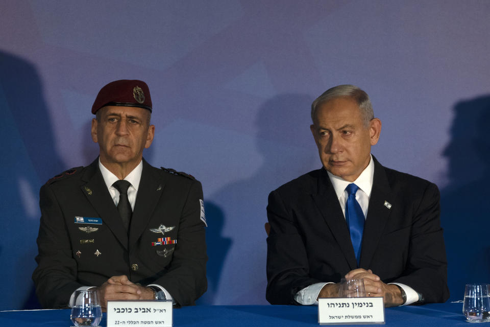 Israel's Prime Minister Benjamin Netanyahu, right, and outgoing Israel Defense Forces Chief of Staff, Aviv Kochavi, left, during a transition ceremony to promote incoming Chief of Staff Herzi Halevi to the rank of Lieutenant-General, in Jerusalem, Monday, Jan. 16, 2023. (AP Photo/ Maya Alleruzzo, Pool)