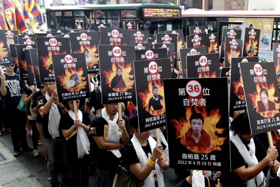 Activists displaying portraits of people who killed themselves in self-immolation take part in a rally to support Tibet, in Taipei, Taiwan on March 10, 2013. (Pichi Chuang/Reuters)