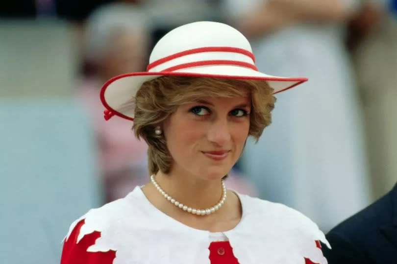 Diana, Princess of Wales, wears an outfit in the colours of Canada during a state visit to Edmonton, Alberta, with King Charles III.