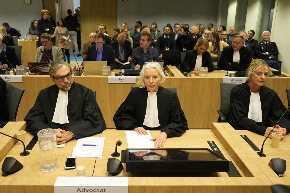 Peter Langstraat, left, along with other lawyers of the victims sit in court before the verdict session of the Malaysia Airlines Flight 17 trial at the high security court at Schiphol airport, near Amsterdam, Netherlands, Thursday, Nov. 17, 2022. The Hague District Court, sitting at a high-security courtroom at Schiphol Airport, is passing judgment on three Russians and a Ukrainian charged in the downing of Malaysia Airlines flight MH17 over Ukraine and the deaths of all 298 passengers and crew on board, against a backdrop of global geopolitical upheaval caused by Russia's full-blown invasion of Ukraine in February and the nearly nine-month war it triggered. (AP Photo/Phil Nijhuis)