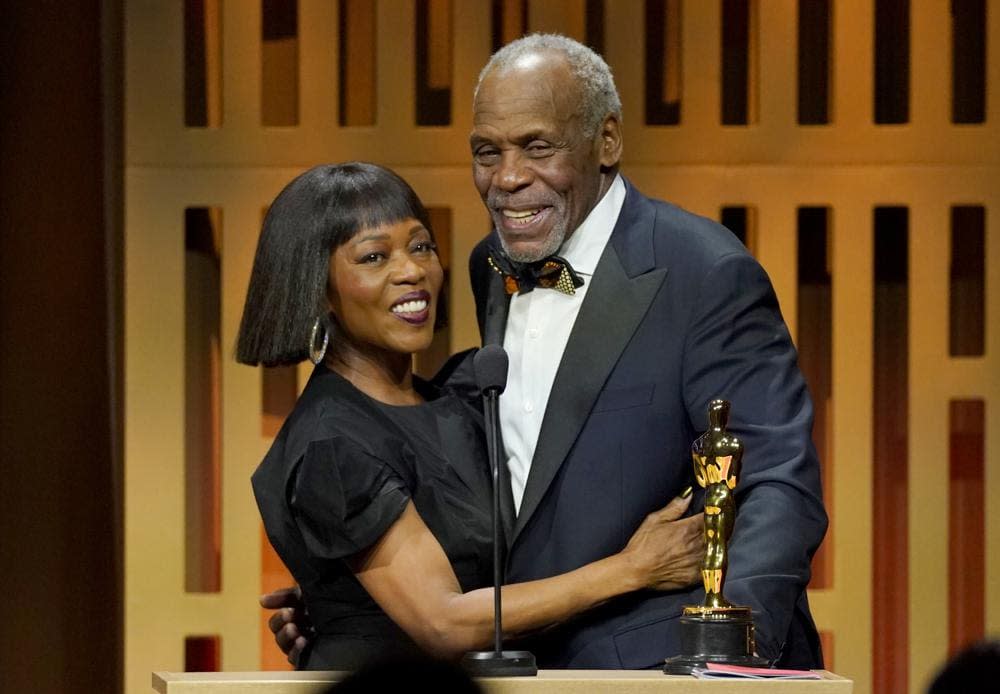 Alfre Woodard, left, presents Danny Glover with the Jean Hersholt Humanitarian Award at the Governors Awards on Friday, March 25, 2022, at the Dolby Ballroom in Los Angeles. (AP Photo/Chris Pizzello)