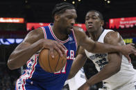 Philadelphia 76ers guard Joel Embiid, left, drives while defended by Memphis Grizzlies center Trey Jemison (55) during the second half of an NBA basketball game Saturday, April 6, 2024, in Memphis, Tenn. (AP Photo/Nikki Boertman)