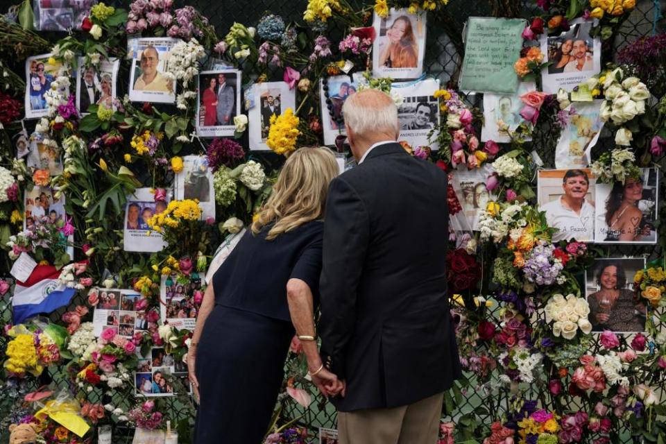 Joe Biden and first lady Jill Biden visit a memorial put in place for the victims of the building collapse.