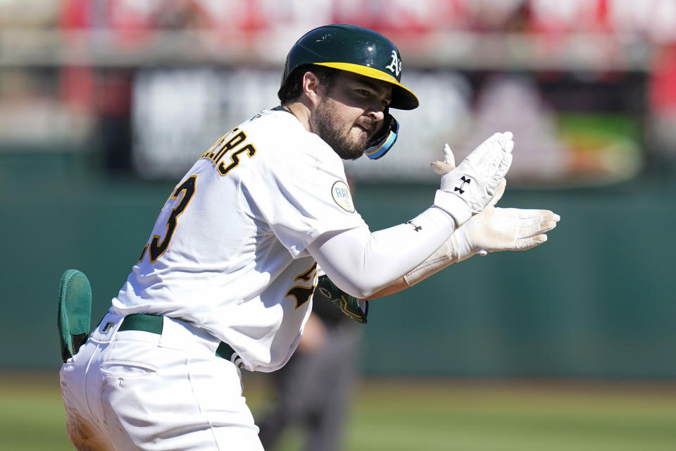 Oakland Athletics' Shea Langeliers celebrates after hitting an RBI-triple against the Seattle Mariners during the eighth inning of a baseball game in Oakland, Calif., Sunday, Aug. 21, 2022. (AP Photo/Godofredo A. Vásquez)